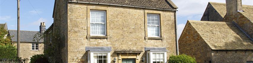 Sunny day showing detached house with teal coloured door